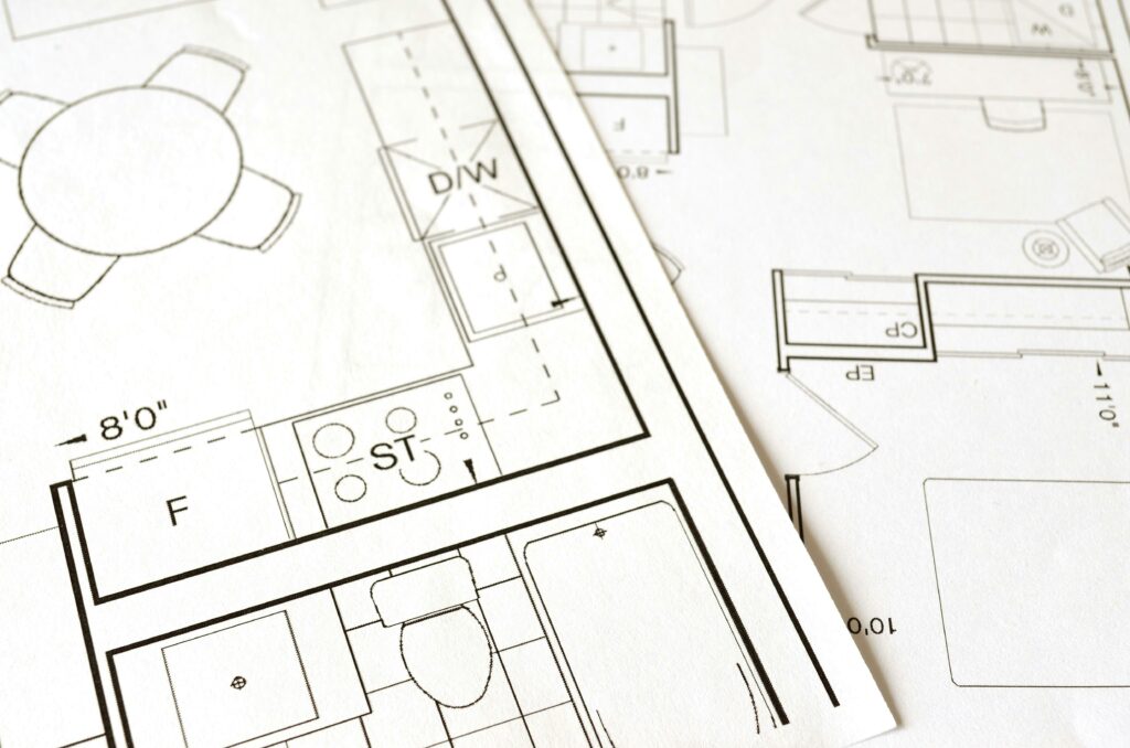 pexels-photo-271667-271667-1 Close-up view of an architectural floor plan on paper showcasing detailed room layouts and measurements.